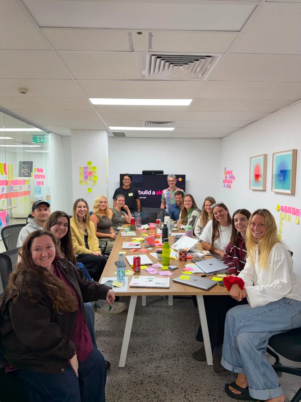 The Bread Agency team smiling around the table at their Learn and Build workshop